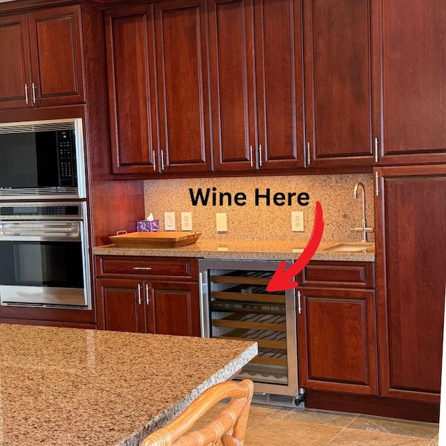 62-3600 Amaui Pl Unit 345, Kamuela, HI 96743 - kitchen with appliances with stainless steel finishes, wine cooler, light stone countertops, and backsplash