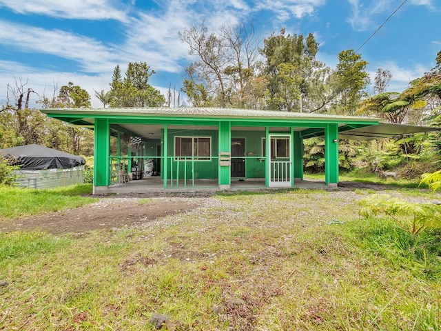 11-3057 Anuhea St, Volcano, HI 96785 - view of front facade featuring a metal roof and a front lawn