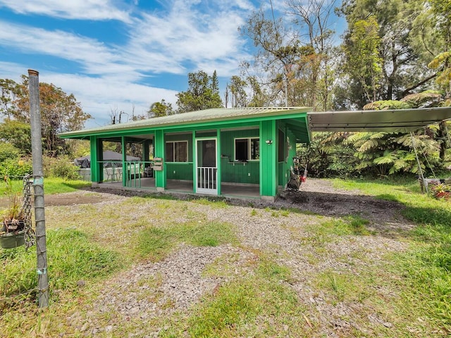 11-3057 Anuhea St, Volcano, HI 96785 - view of front facade featuring a sunroom and a metal roof