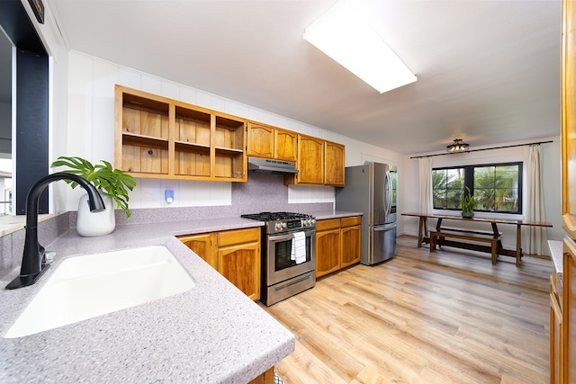 17-436 Ipuaiwaha St, Keaau, HI 96749 - kitchen with appliances with stainless steel finishes, under cabinet range hood, brown cabinetry, light countertops, and light wood finished floors