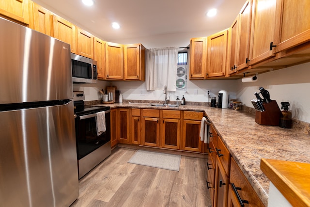 75-5863 Kuakini Hwy Unit 104, Kailua-Kona, HI 96740 - kitchen featuring stainless steel appliances, light wood finished floors, recessed lighting, light stone countertops, and brown cabinets