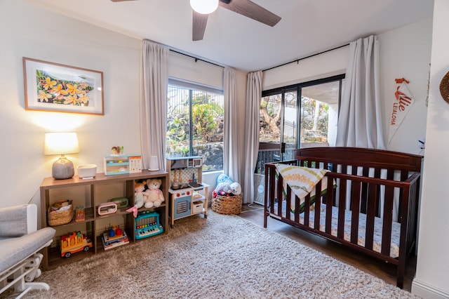 75-5863 Kuakini Hwy Unit 104, Kailua-Kona, HI 96740 - bedroom featuring a nursery area, wood finished floors, and ceiling fan