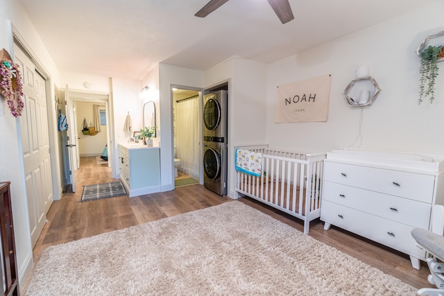 75-5863 Kuakini Hwy Unit 104, Kailua-Kona, HI 96740 - bedroom with stacked washer and clothes dryer, wood finished floors, ensuite bath, and a closet