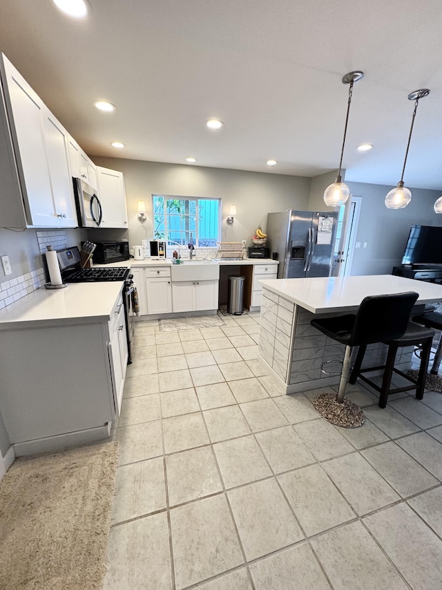 68-3521 Makuahine St, Waikoloa, HI 96738 - kitchen with stainless steel appliances, light countertops, recessed lighting, backsplash, and decorative light fixtures