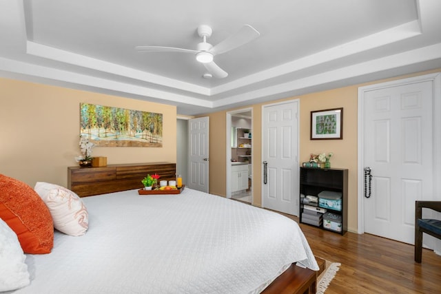 68-1740 Akaula St, Waikoloa, HI 96738 - bedroom featuring a tray ceiling, dark wood-type flooring, ensuite bathroom, and ceiling fan