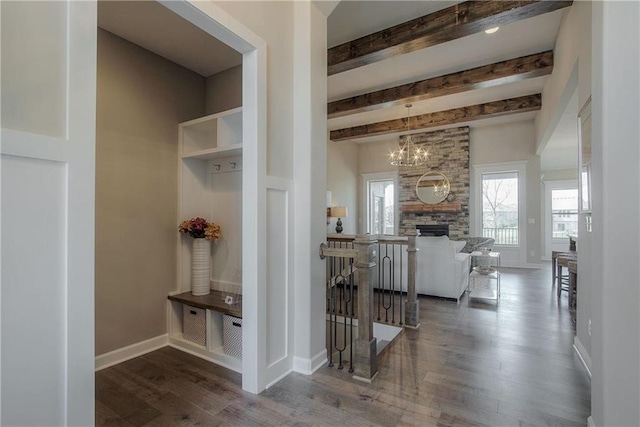 interior space featuring beam ceiling, dark hardwood / wood-style flooring, and a chandelier