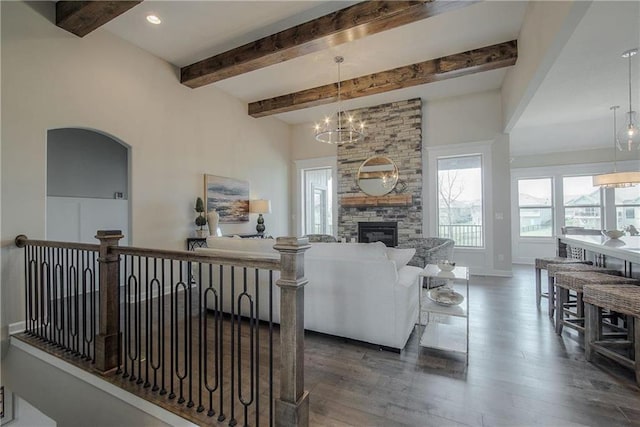 living room with an inviting chandelier, dark hardwood / wood-style flooring, and a fireplace