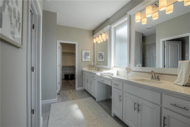 bathroom featuring double sink and vanity with extensive cabinet space