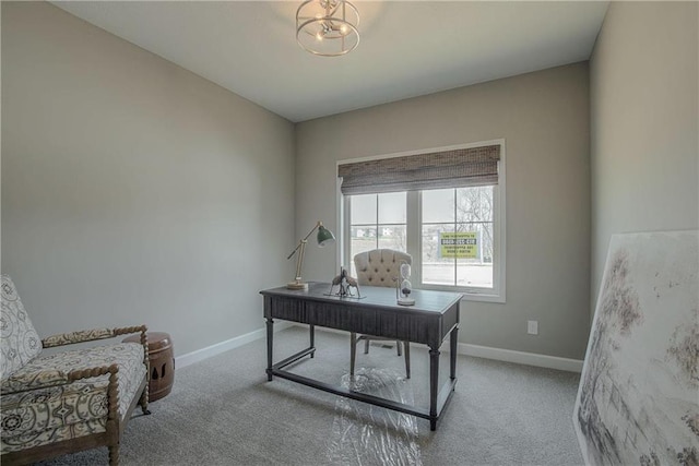 carpeted office featuring an inviting chandelier