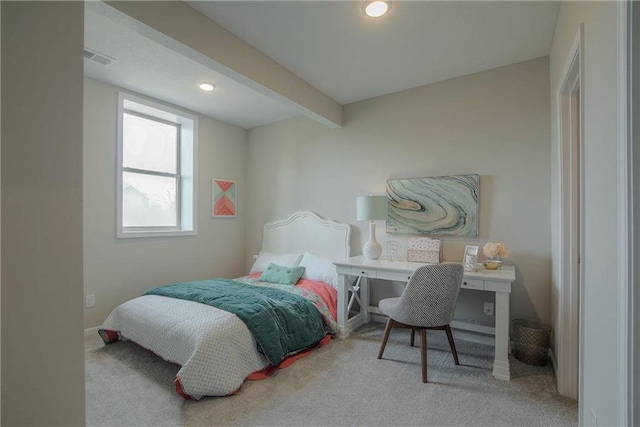 carpeted bedroom featuring beamed ceiling