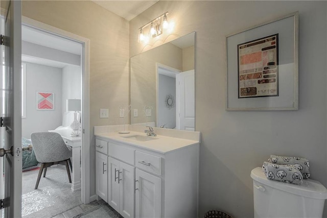 bathroom featuring toilet and large vanity