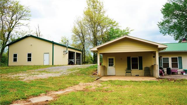 rear view of house featuring a patio area and a yard