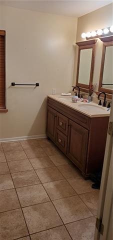 bathroom with double vanity and tile floors