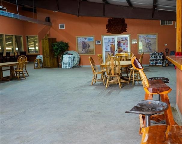 dining space featuring concrete floors