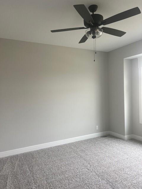 spare room with carpet floors and ceiling fan