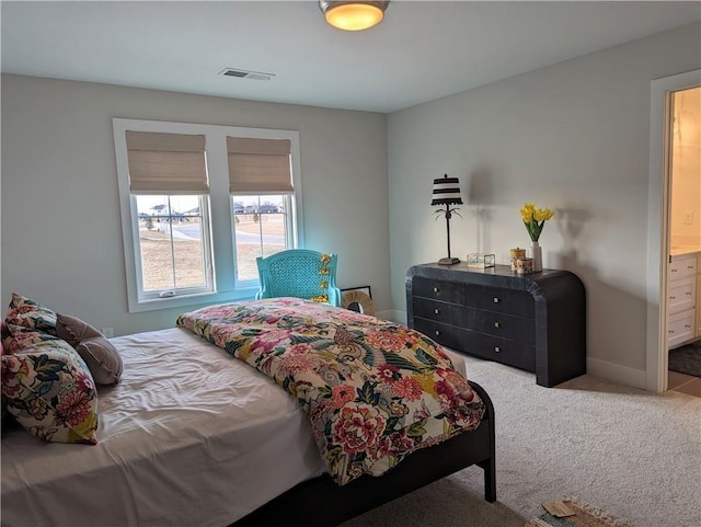 carpeted bedroom featuring connected bathroom