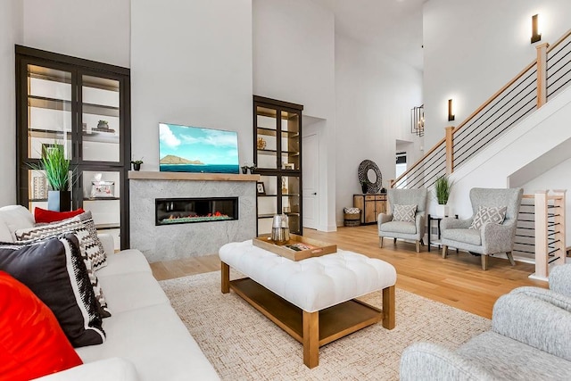 living room featuring wood-type flooring and a towering ceiling