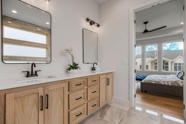 bathroom featuring vanity, hardwood / wood-style floors, and ceiling fan