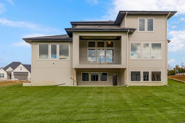 back of house with a yard and a balcony