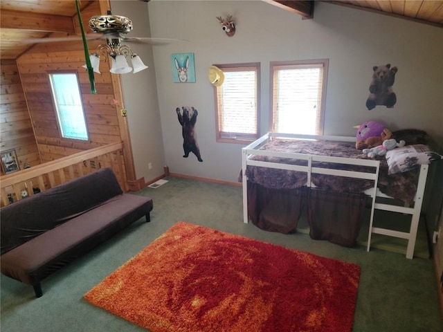 carpeted bedroom featuring wood walls, vaulted ceiling with beams, and ceiling fan