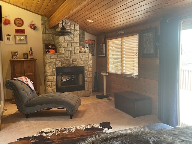 living room with carpet flooring, a stone fireplace, wood ceiling, vaulted ceiling with beams, and wood walls