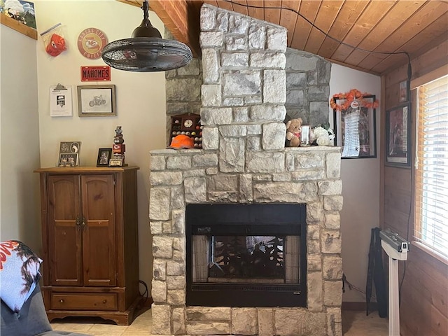 interior details with a stone fireplace and wooden ceiling