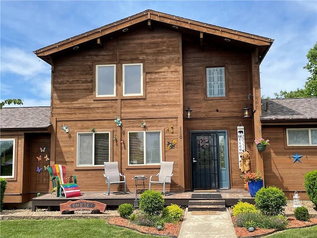 rear view of house with an outdoor fire pit