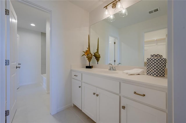 bathroom with tile patterned flooring,  shower combination, and vanity