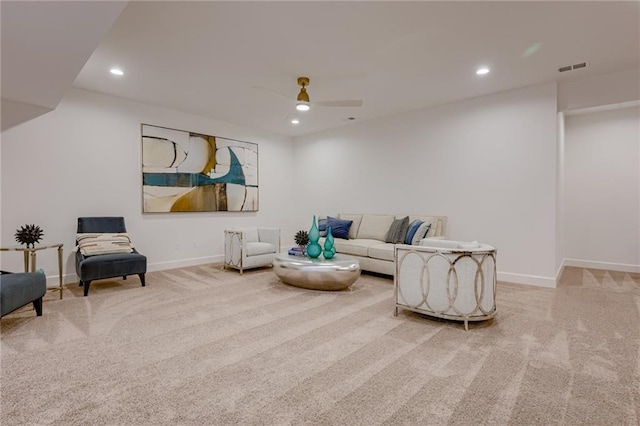 carpeted living room featuring ceiling fan