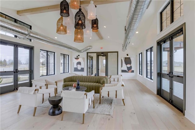 interior space featuring light hardwood / wood-style flooring, beam ceiling, french doors, and high vaulted ceiling