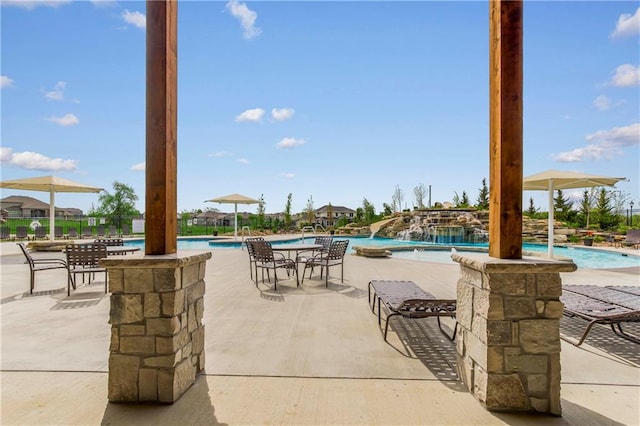 view of patio / terrace with pool water feature and a community pool