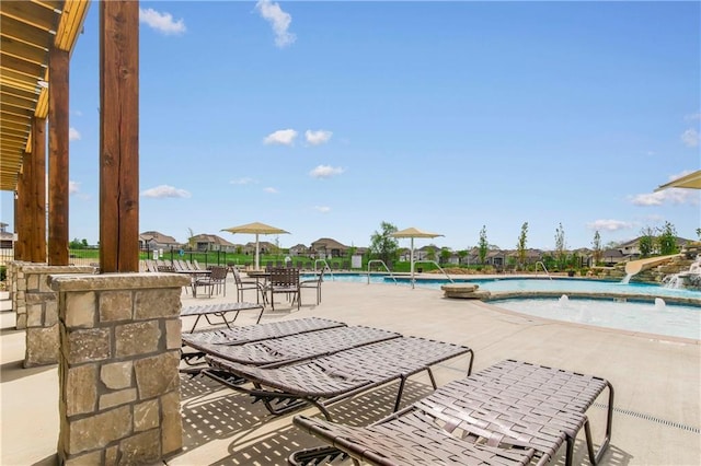 view of patio featuring pool water feature and a community pool