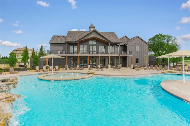 view of swimming pool featuring pool water feature and a patio area