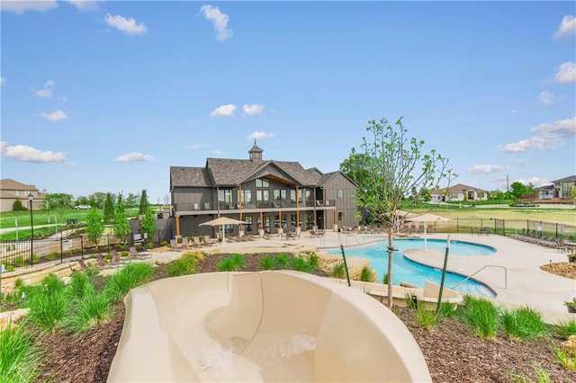 exterior space with a balcony, a patio area, and a community pool