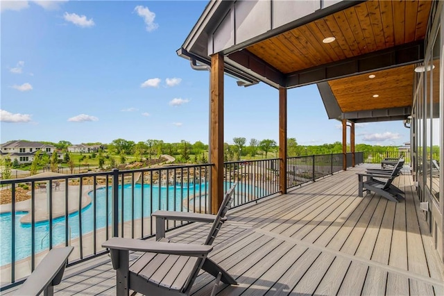 wooden terrace featuring a fenced in pool