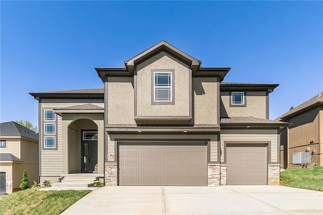 view of front of home with a garage and central AC unit