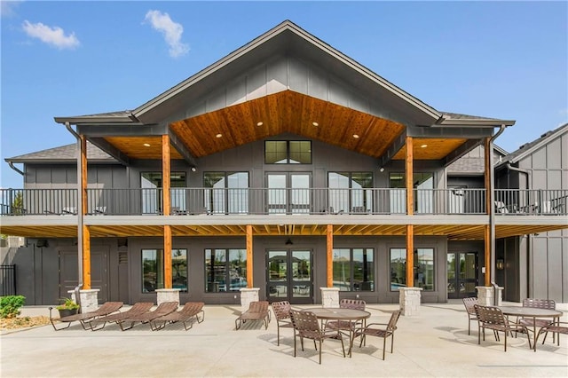 back of property featuring a balcony and a patio area