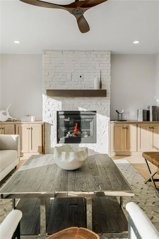 2301 W 180th St, Overland Park, KS 66085 - living room with ceiling fan, a stone fireplace, light wood-style flooring, and recessed lighting