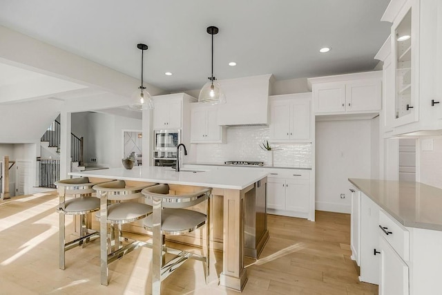 2301 W 180th St, Overland Park, KS 66085 - kitchen with stainless steel microwave, tasteful backsplash, white cabinets, and recessed lighting