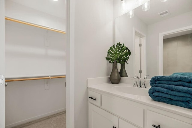 2301 W 180th St, Overland Park, KS 66085 - bathroom featuring vanity, a spacious closet, and baseboards