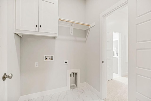 2301 W 180th St, Overland Park, KS 66085 - laundry area with washer hookup, electric dryer hookup, cabinet space, baseboards, and light marble finish flooring
