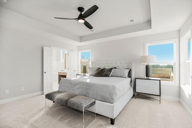 2301 W 180th St, Overland Park, KS 66085 - bedroom with light carpet, baseboards, a raised ceiling, and ceiling fan