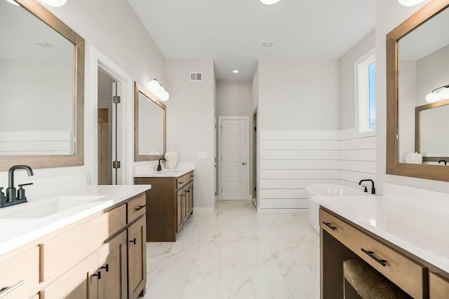 2301 W 180th St, Overland Park, KS 66085 - full bath with marble finish floors, two vanities, a freestanding bath, and recessed lighting