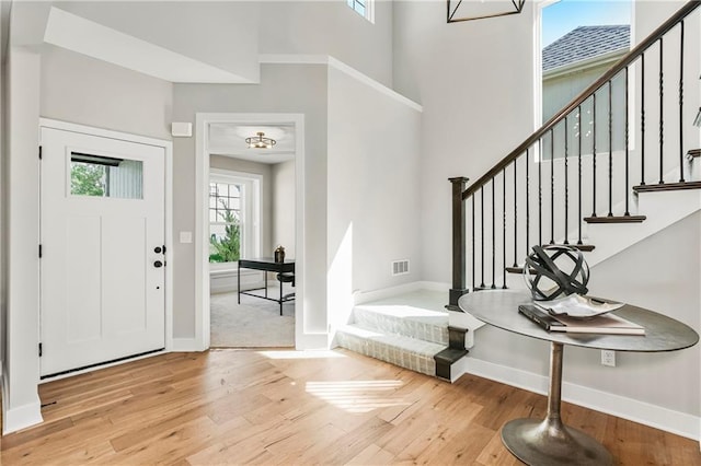 25025 W 92nd St, Lenexa, KS 66227 - entrance foyer with baseboards, visible vents, stairway, and wood-type flooring