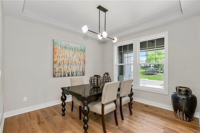 25025 W 92nd St, Lenexa, KS 66227 - dining area with baseboards, visible vents, wood finished floors, and an inviting chandelier