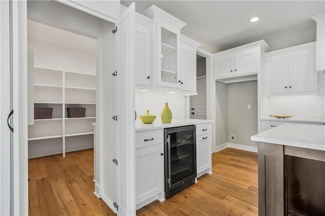 25025 W 92nd St, Lenexa, KS 66227 - kitchen featuring wine cooler, light wood-style floors, and backsplash