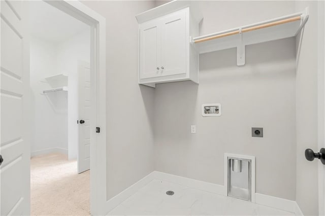 laundry area with hookup for a washing machine, hookup for an electric dryer, and cabinets