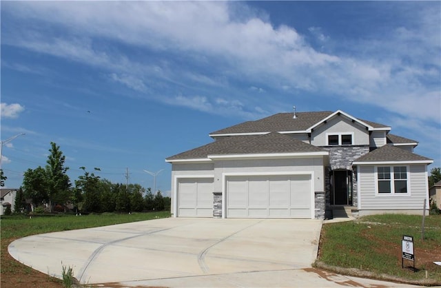 view of front facade with a front yard and a garage