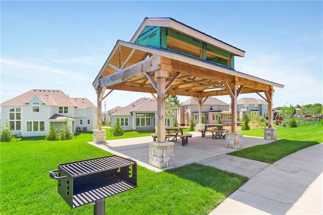 surrounding community with a gazebo, a lawn, and a patio area