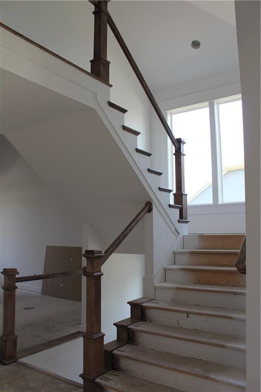 stairway featuring concrete floors